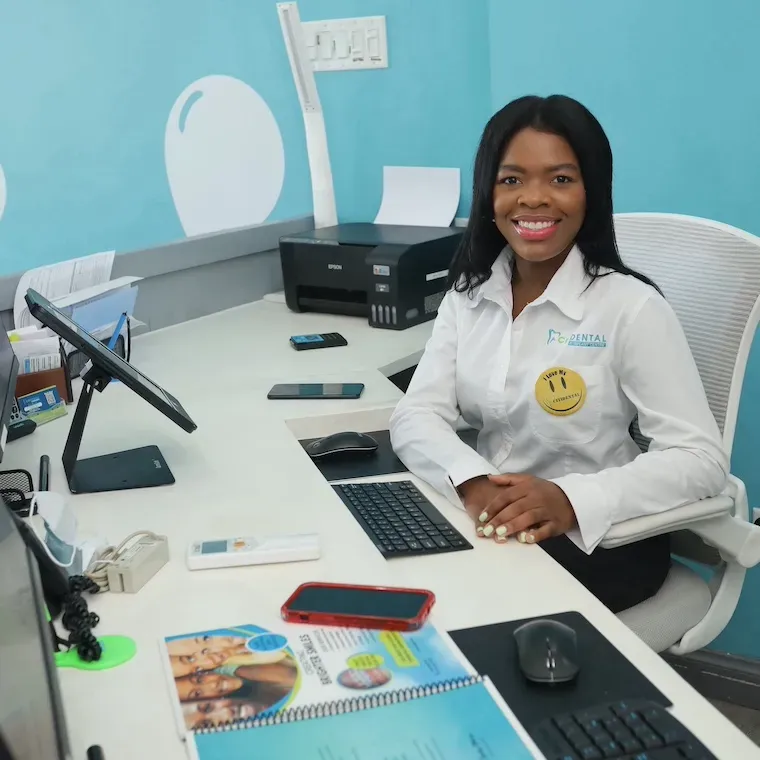 A Citidental team member smiling from the front desk